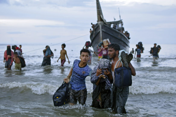 Ethnic Rohingya disembark from their boat upon landing on the north coast of Sumatra, Indonesia, in November.