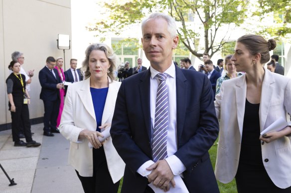 Clare O’Neil and Andrew Giles leave  a press conference after telling the gathered media they had to go to a division in the House.