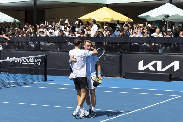 Spectators cheer John Millman and Edward Winter in their doubles match on court six on Thursday.