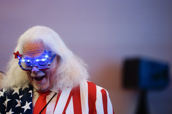 A man walks in the hotel ballroom at a Herschel Walker election night watch party on Tuesday.