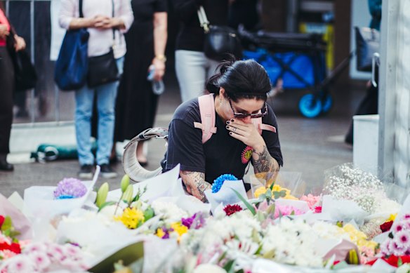 A mourner pays tribute outside Westfield Bondi Junction after the stabbings.