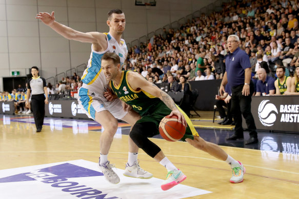 Nathan Sobey drives past Roman Marchuk of Kazakhstan.