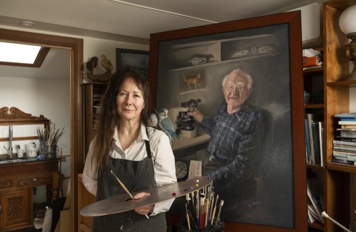 Artist Lulu Clifton-Evans with her portrait of Hans Brunner.