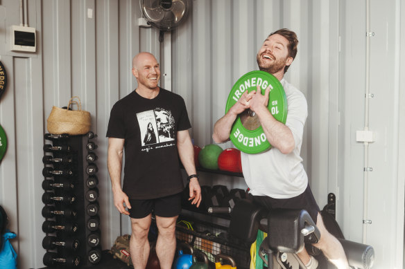 David Pocock looks on as Angus Thompson works out in the senator’s home gym.