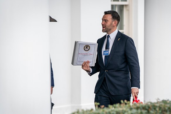 Far-right political activist Jack Posobiec leaves the White House with “The Epstein Files: Phase 1” in February.