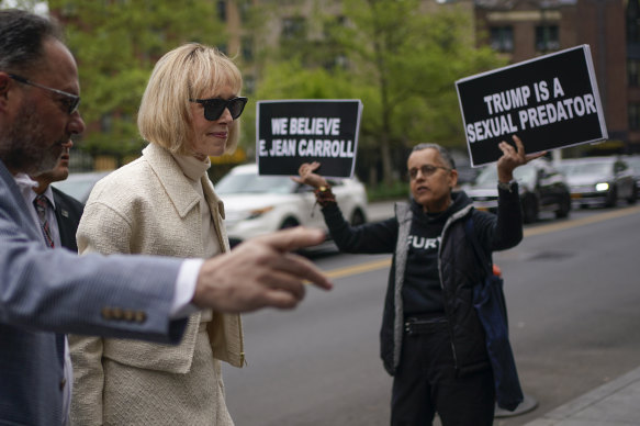 E Jean Carroll is met by supporters as she arrives at court in New York. 