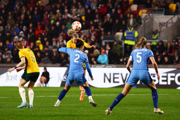 Australia’s Charlie Grant heads the ball past Lucy Bronze to score against England in April.