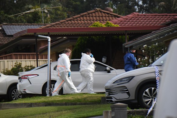 Police at a house in Rosemeadow, where three people died in an attack on Sunday morning.