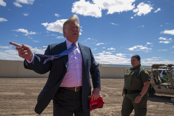 US President Donald Trump visits a section of the border wall with Mexico in Calexico, California, in April. 