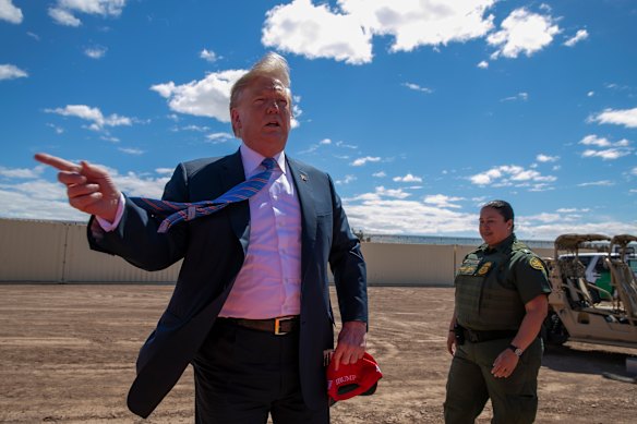 US President Donald Trump visits a section of the border wall with Mexico in Calexico, California, in April. 