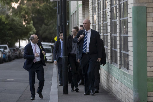 Federal police leave the construction union's headquarters on Wednesday evening.