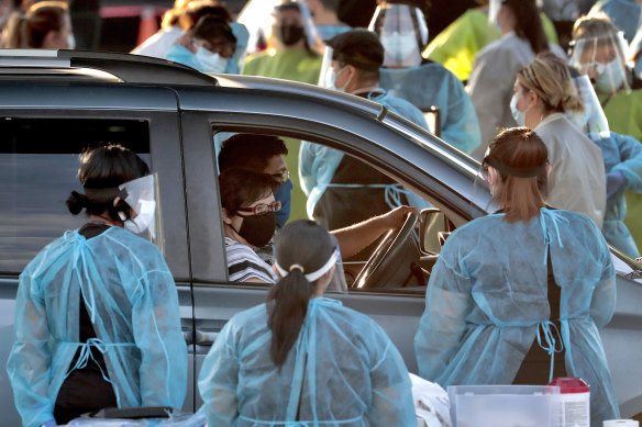 A family pulls up to a drive-through testing site in Phoenix, Arizona.