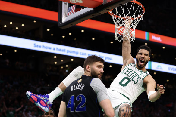 Jayson Tatum #0 of the Boston Celtics reacts as he dunks the ball against Maxi Kleber #42 of the Dallas Mavericks.