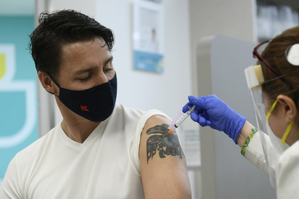 Prime Minister Justin Trudeau receives his second dose of COVID-19 vaccine from a pharmacist in Ottawa earlier this month. 