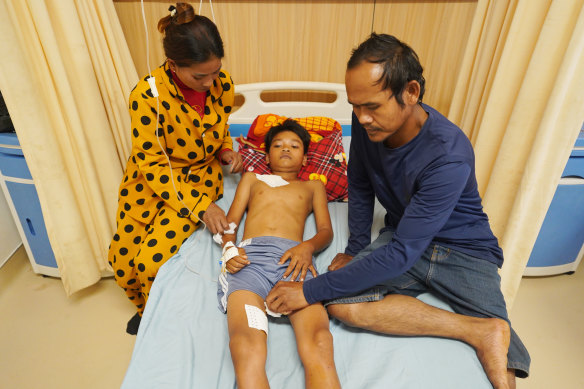 Saly with his parents at his Chinese-built and funded hospital in Cambodia.