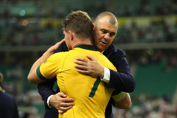 Wallabies coach Michael Cheika  and captain Michael Hooper embrace after Australia's loss to England.