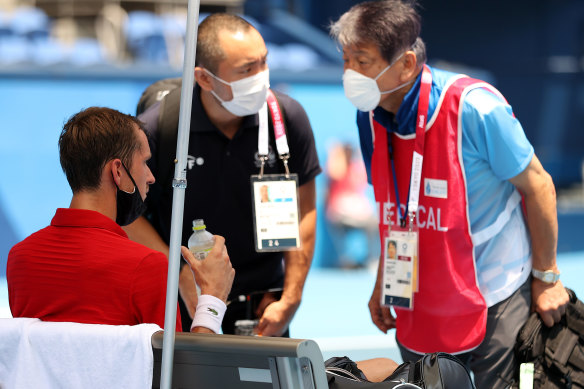Daniil Medvedev receives medical attention during the Tokyo Games.
