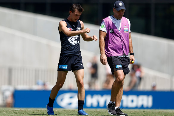 Jagga Smith limps from the field in the match simulation against St Kilda.