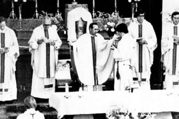 Bishop Ronald Mulkearns officiates at a mass in 1980. 