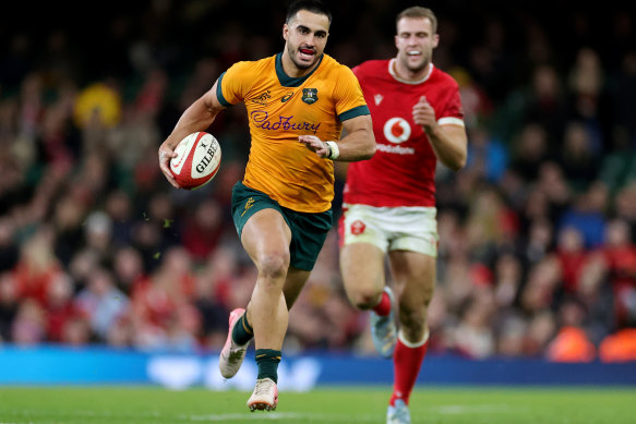 Tom Wright races away for one of his three tries against Wales.
