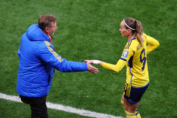 Sweden’s Kosovare Asllani shakes hands with coach Peter Gerhardsson after being substituted off.