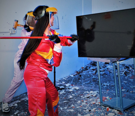 Let her rip: A customer destroys a TV at The Smash Room.