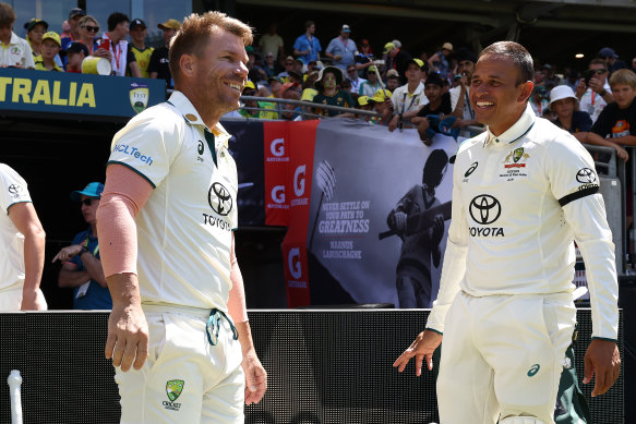 Usman Khawaja, pictured with David Warner, wearing the black armband on the first day of the Perth Test.