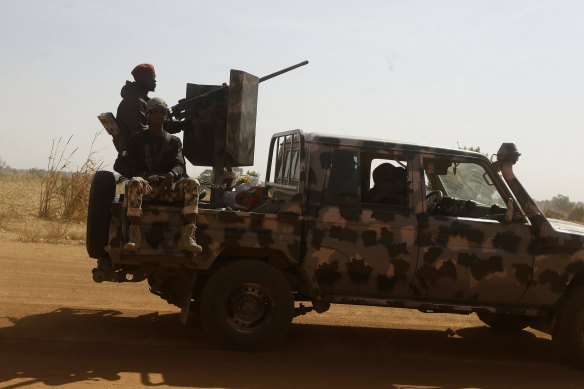 Nigerian soldiers drive past a secondary school in Kankara in December. Rebels have abducted hundreds of school children in several attacks in Nigeria.