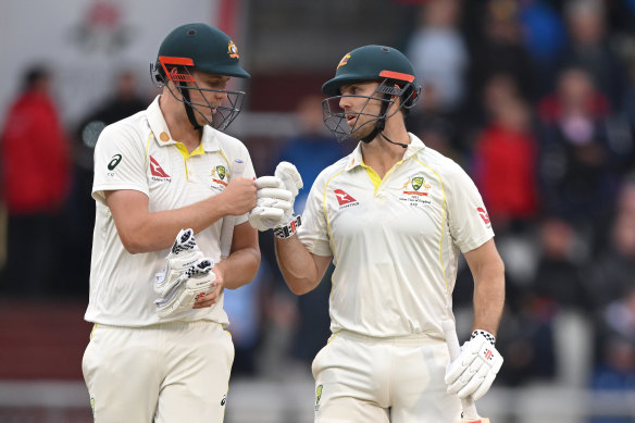 Australia batsmen Cameron Green and Mitchell Marsh fist pump as they leave the field.