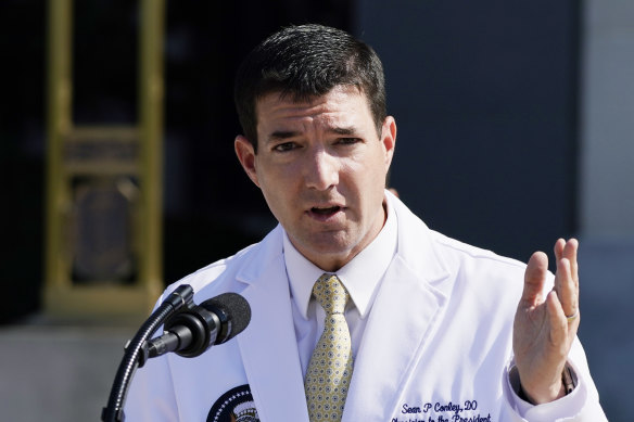 Dr Sean Conley briefs reporters outside the Walter Reed National Military Medical Centre in Bethesda on Sunday.