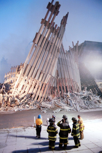New York City firefighters look at the destroyed facade of the World Trade Centre on September 13, 2001.