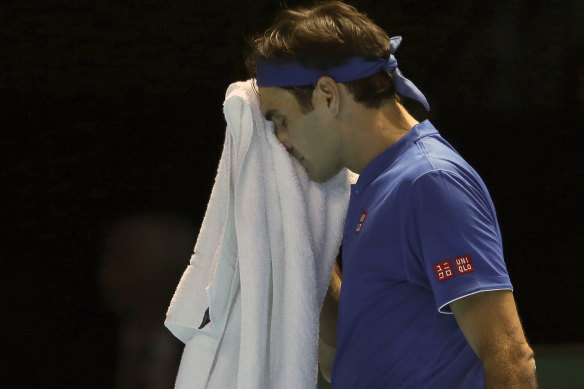 Toweled up: Roger Federer wipes his face during his straight sets loss to Kei Nishikori.