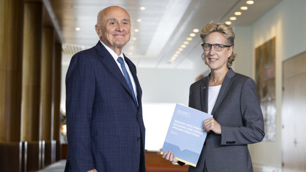 Professor Allan Fels hands over the report into Price Gouging and Unfair Pricing Practices to ACTU Secretary Sally McManus, at Parliament House in Canberra on Tuesday.