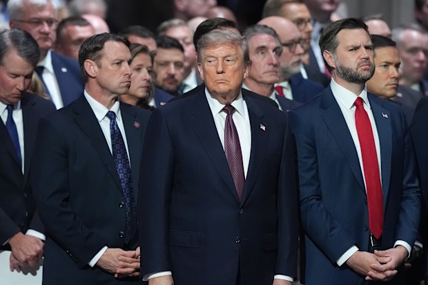 Donald Trump and JD Vance at Lindsey Graham’s funeral. Volodymyr Zelensky can be seen in the distance.