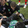 Photographer bowled by celebrating Croatia players keeps snapping