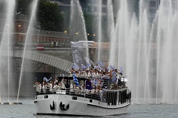 Team Greece’s boat parades along the Seine river during the opening ceremony.