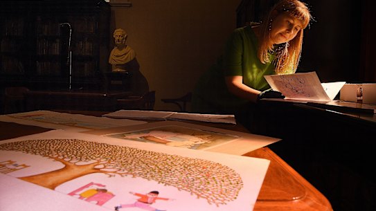 NSW State Library curator Sarah Morley inspects illustrations by children’s author and illustrator Pamela Allen that will be on display from Monday 24th of August.