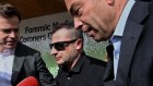 Anthony Koletti (centre) the husband of Melissa Caddick leaves Lidcombe coroners court in Sydney.  