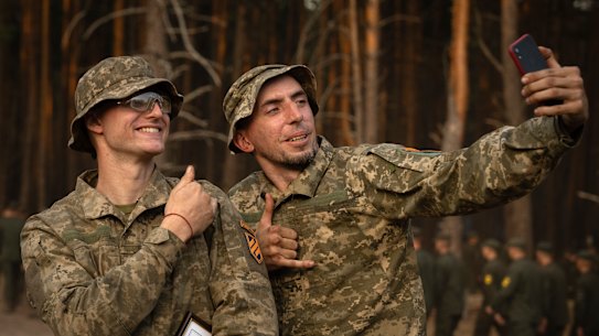 Newly recruited soldiers of the 3rd assault brigade take selfie to mark the end of their training at a military base close to Kyiv.