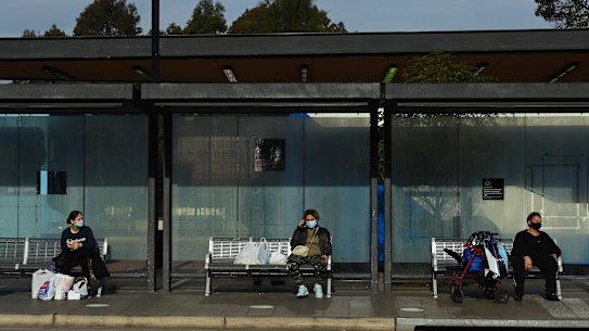 People wait for buses at Fairfield during Sydney’s COVID-19 lockdown. 