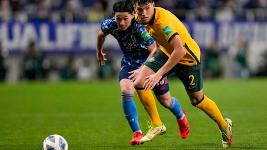Australia’s Fran Karacic, right, and Japan’s Takumi Minamino battle for the ball.