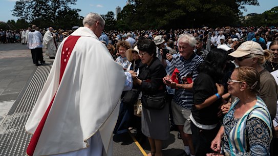 People are seen during a pontifical requiem Mass for Cardinal George Pell.