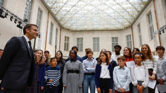 French President Emmanuel Macron and students at the Cite Internationale de la Langue Francaise, a cultural centre dedicated to the French language and French-speaking cultures at the castle of Villers-Cotterets on Monday.