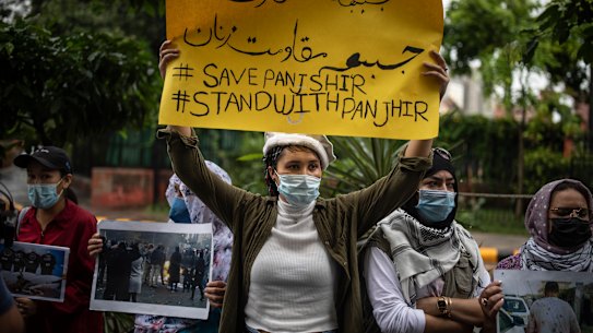 Afghan women hold placards during a protest against Pakistan and the Taliban takeover of Afghanistan.
