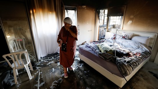 A woman stands in a damaged room after rockets were launched from the Gaza Strip, in Ashkelon, Israel.