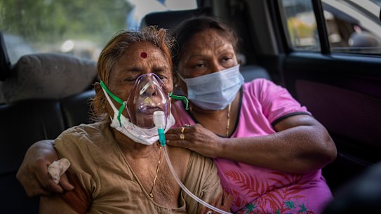 A COVID-19 patient receives oxygen inside a car provided by a Gurdwara, a Sikh house of worship, in New Delhi, India, while waiting for a hospital bed. 