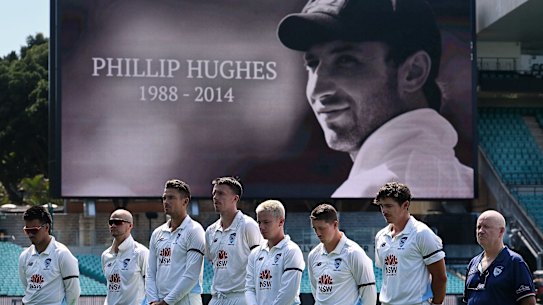 Cricketers from NSW including Sean Abbott (second from right) and Tasmania mark 10 years since cricketer Phillip Hughes died at the SCG.