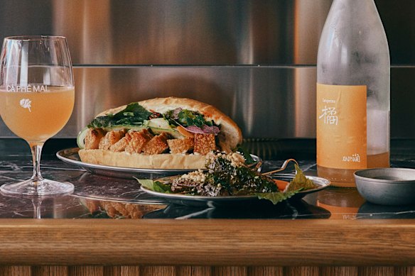 Chicken banh mi and orange Chinese wine.
