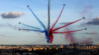 The Patrouille de France, an aerobatics demonstration unit of the French Air Force, trail smoke as they fly over Paris during a parade for French athletes who participated in the 2024 Olympics and Paralympics, 