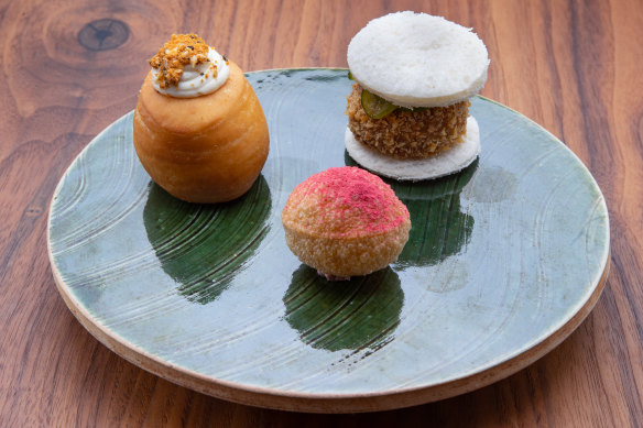 Pani puri filled with duck parfait and raspberry, duck katsu sandwich, and a duck fat-fried doughnut at Underbar.